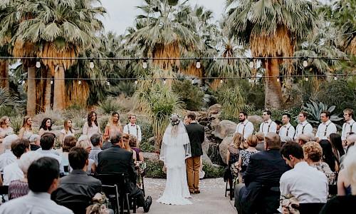Walk down the aisle surrounded by loved ones and the lush grove of trees.